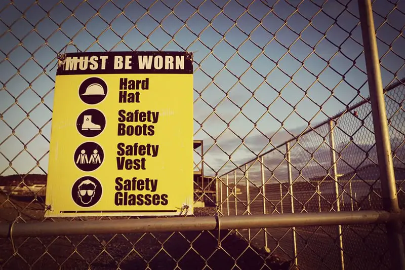 Health and safety at work sign on fence
