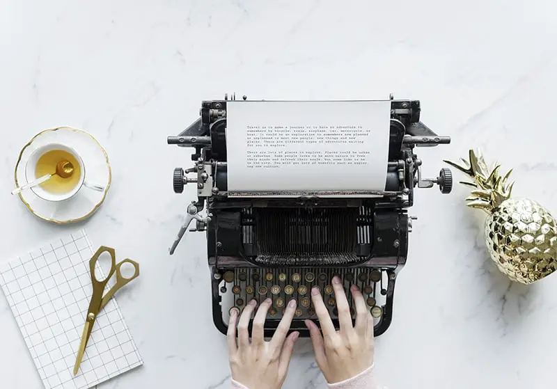 Freelancer working in gig economy typing on typewriter
