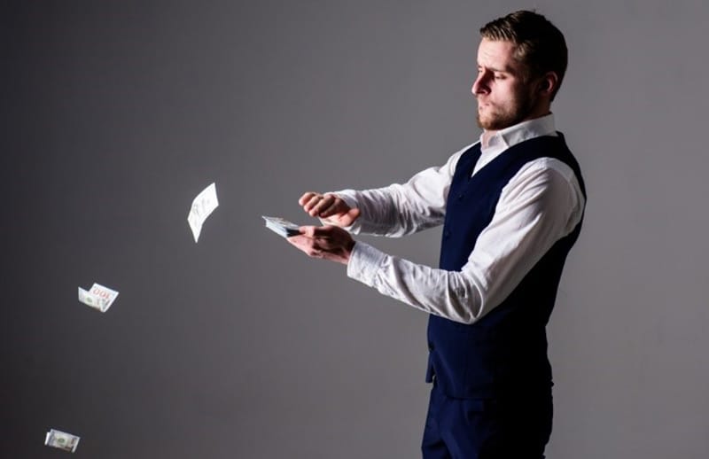 Man throwing away money - wasting money