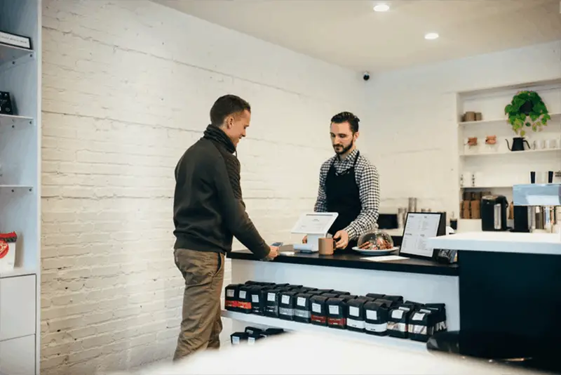 customer paying for products in shop
