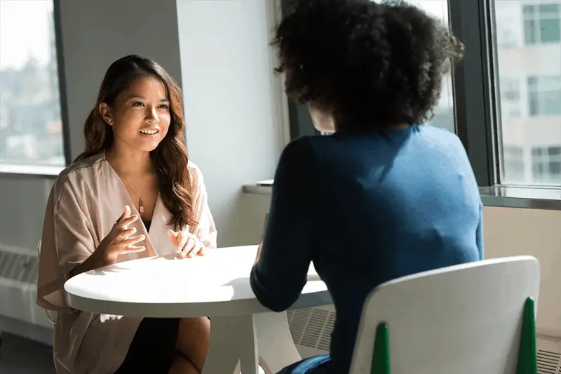 Acing the job interview - two women sat at a round white table