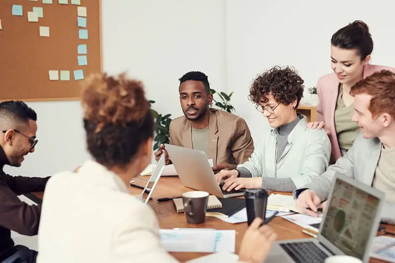 Team of  engaged employees working together around a table