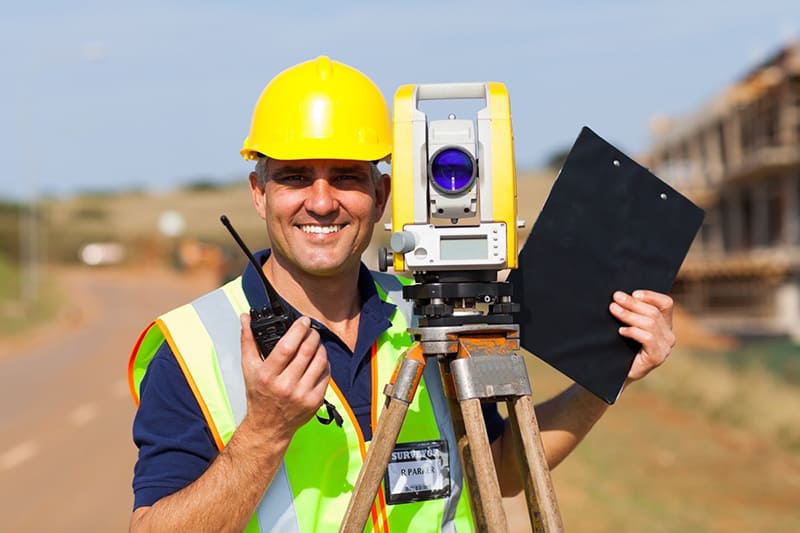 Professional surveyor - land surveyor with equipment