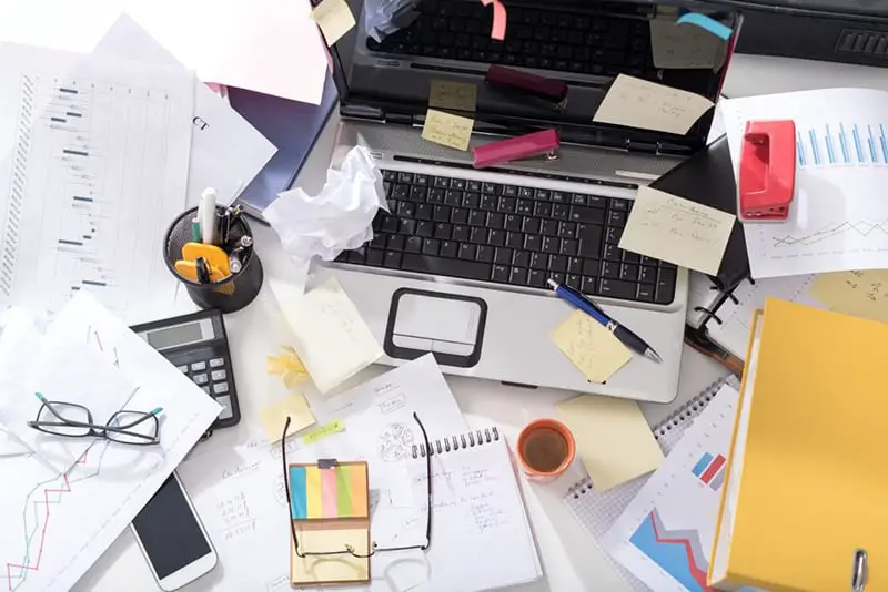 clutter untidy desk - chaos - office organization required.