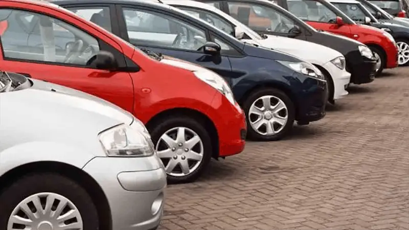 new cars and old cars on forecourt