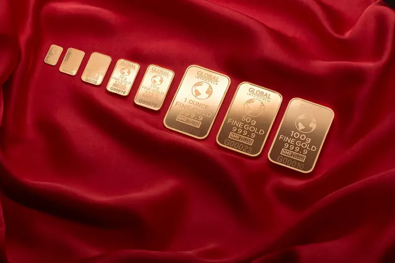 Precious metals - gold bars on red cloth