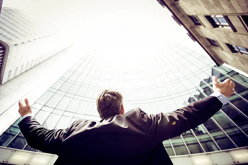 low angle photography of man outside in the middle buildings
