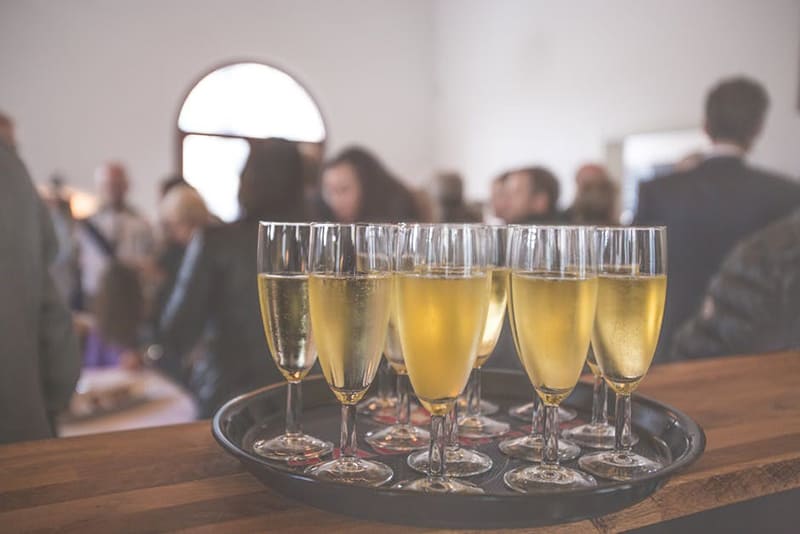 Glasses of wine on tray at office party