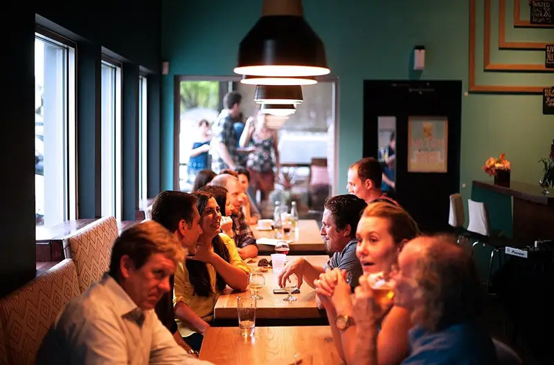 people sitting in restaurant eating and drinking