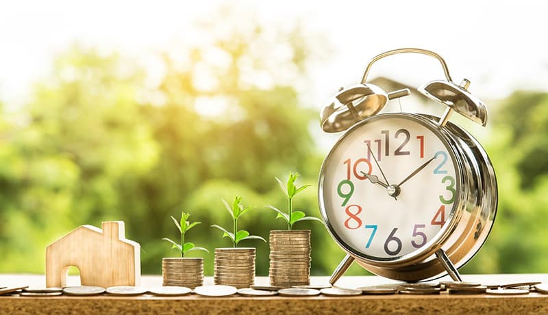 An alarm clock and coins