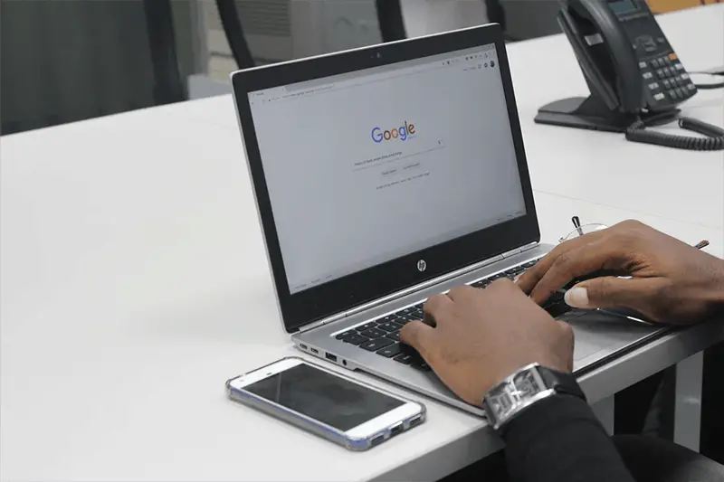 Person using a lpatop to do search on Google search engine