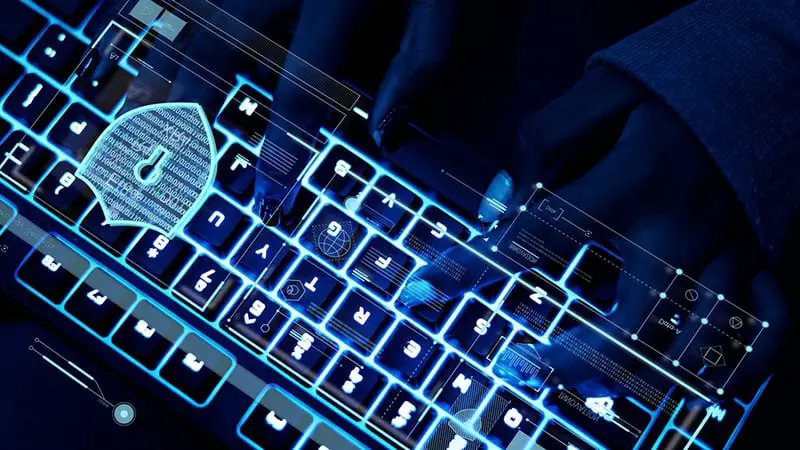 Closeup of hands using a keyboard – cyber security cyber crime - white collar crime