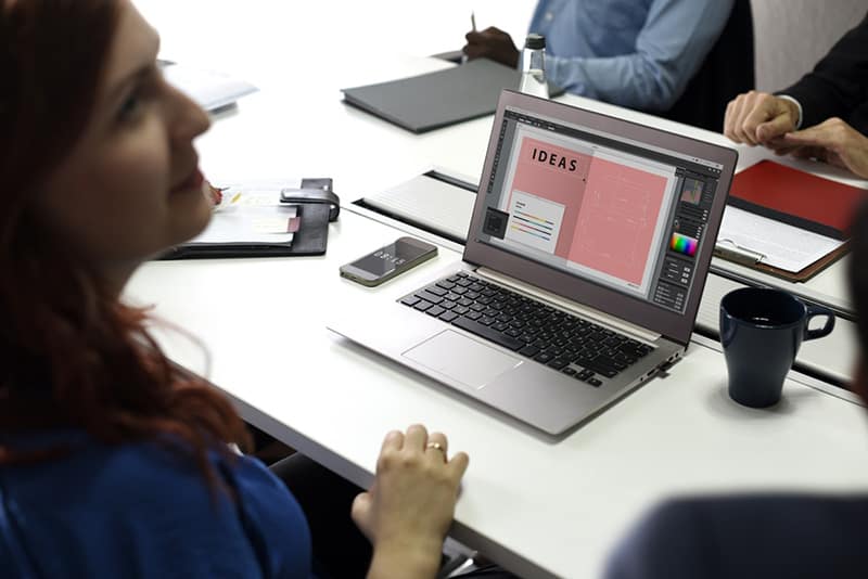 Woman working on logo design ideas on laptop