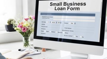 Person completing an application form for a Small Business Loan online