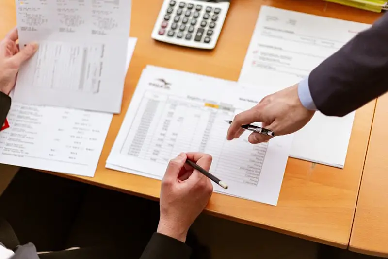 Person holding pen and papers