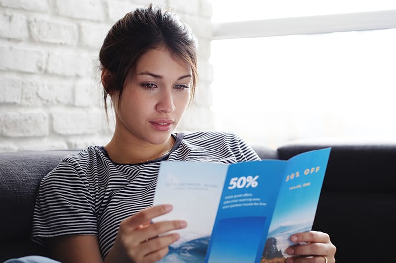 Woman reading a well-designed flyer