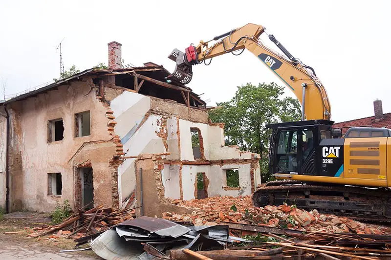 house demolition in progress by person in CAT 329E vehicle