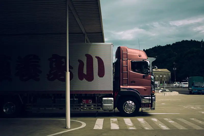 Maroon delivery truck in garage