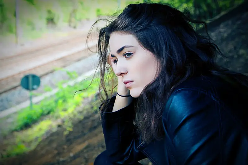 woman looking sad, sitting outside