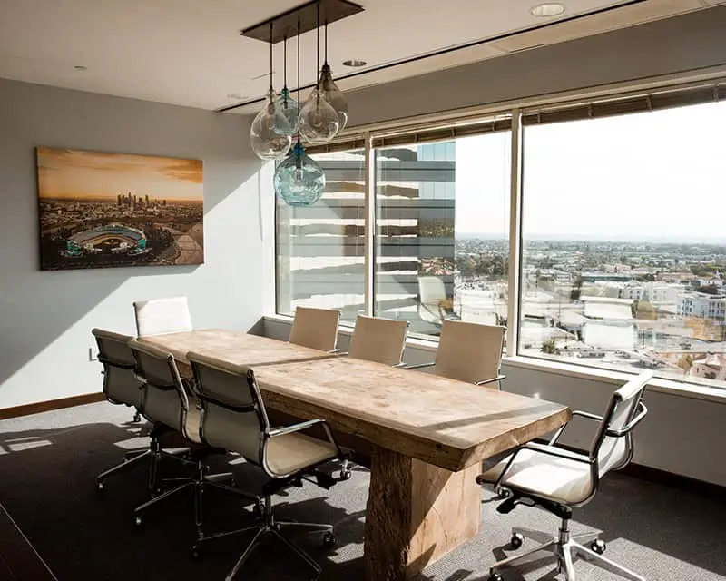 A conference table near the window views the city