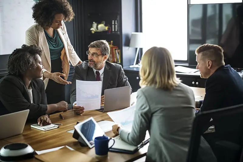 A group of people in a business meeting