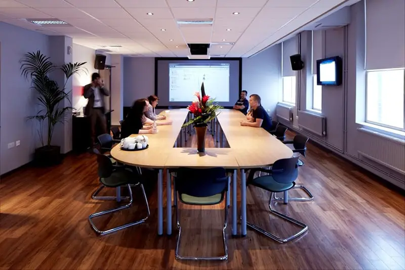 People sat around a conference table in meeting room