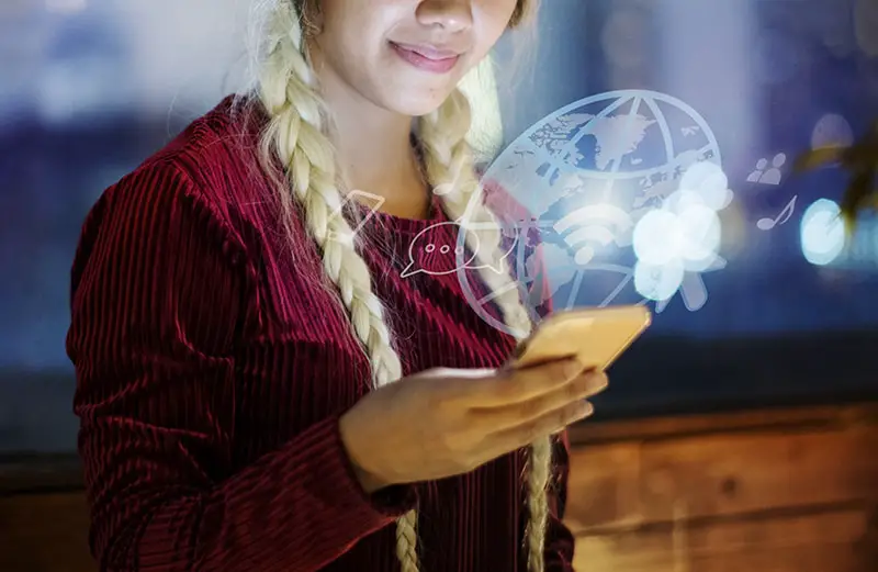 A woman wearing red long sleeves browsing on her smartphone