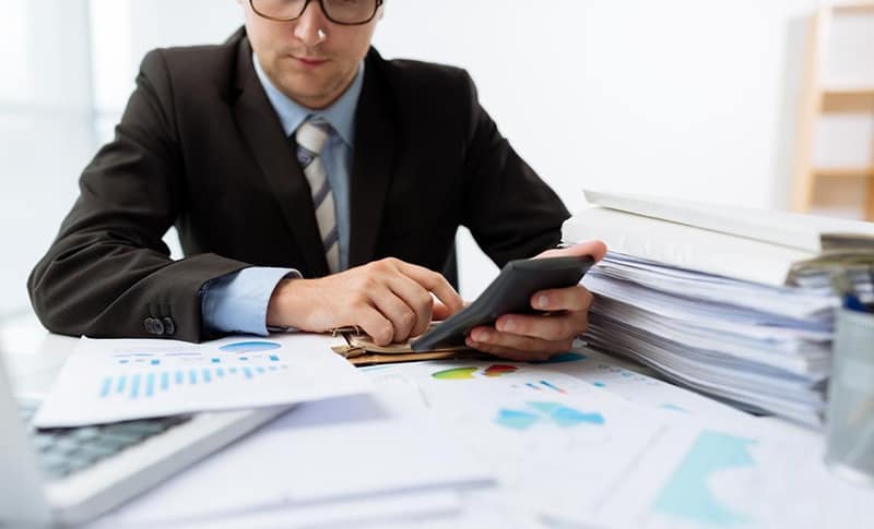 Accountant using a calculator