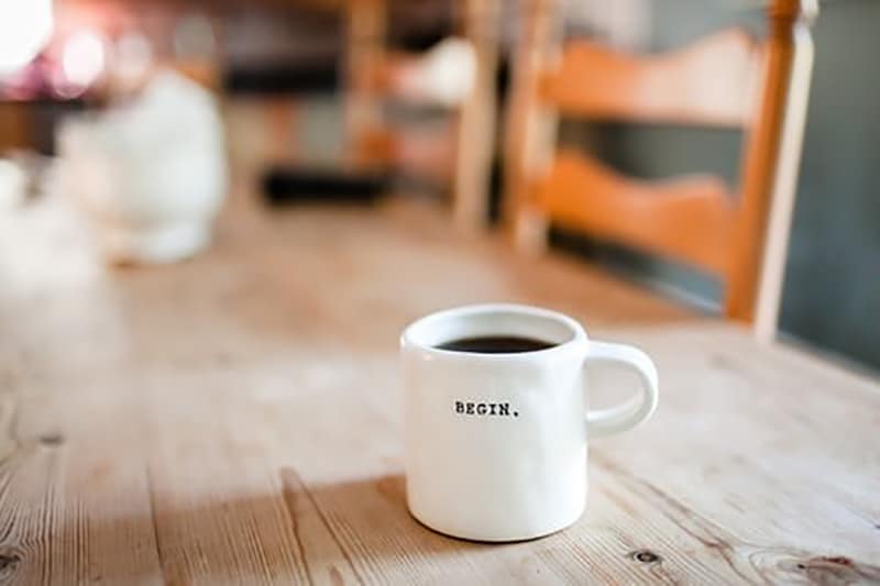 mug on table with the word begin on it