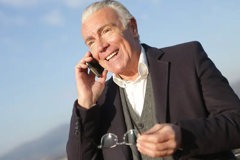 senior executive – mature businessman having a conversation on smartphone in city