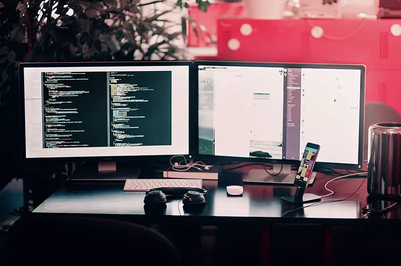 website coding station – two black computer monitors on desk
