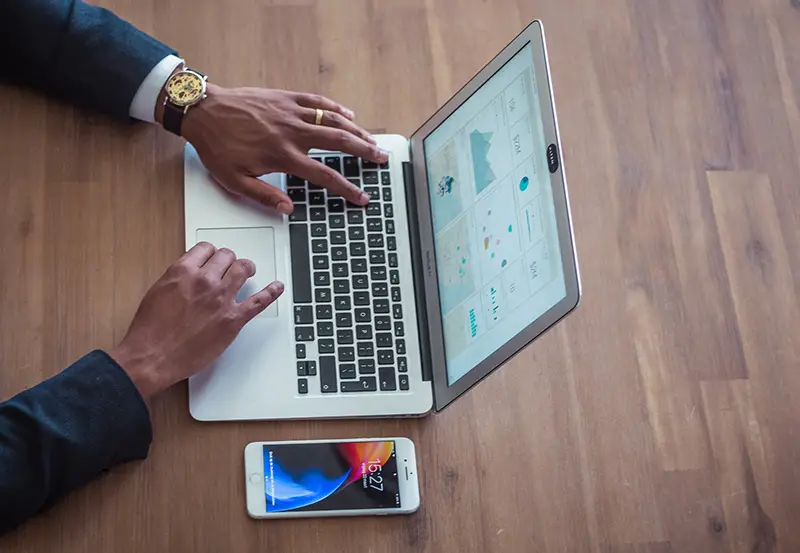 A business man working in a data anaytics in the laptop