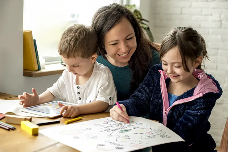 A mother doing a home schooling for her two kids