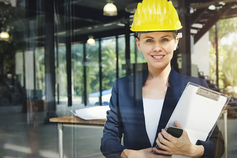 Woman engineer wearing hard hat in site constrauction
