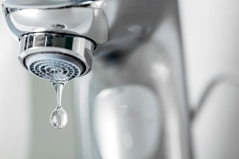 Focused image of dropping water from faucet