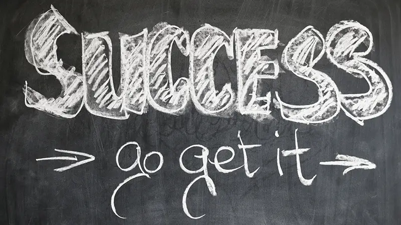 Success go get it written in white chalk on a blackboard
