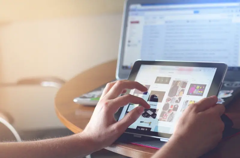 A person browsing on a tablet screen