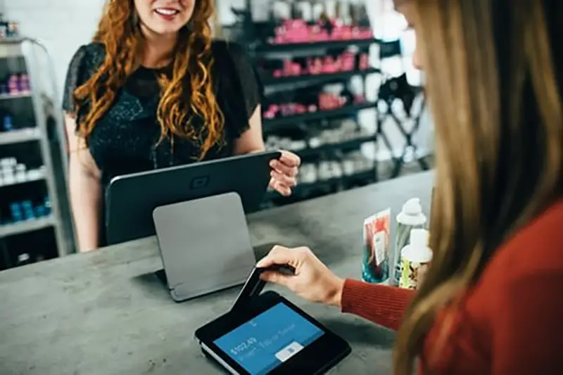 Customer using POS terminal in retail establishment