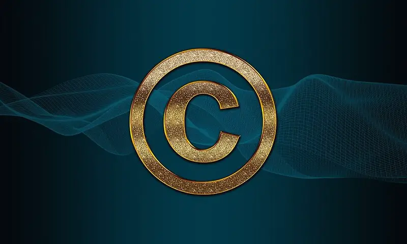 Gold copyright symbol set against teal background