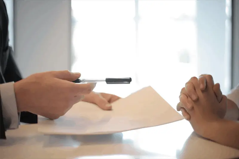 businessman giving contract to woman to sign