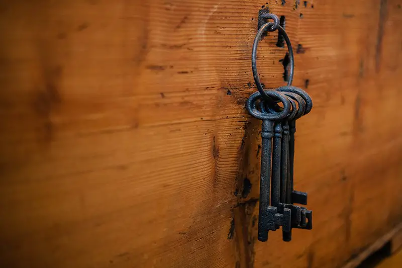 Keys hang in the wooden wall