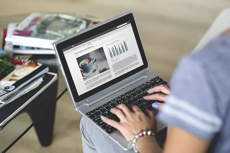 A woman typing on laptop