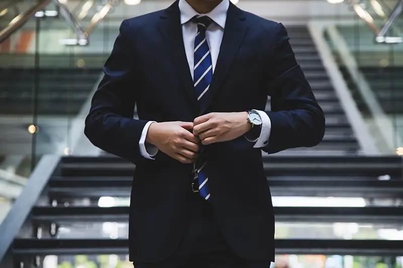 A businessman wearing business suit standing in the stairway 