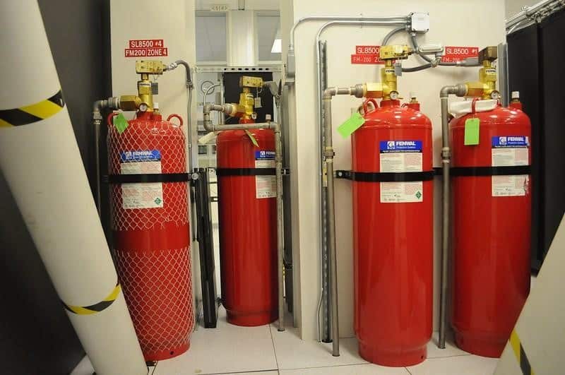 A photo of red cylinders connected to a fire suppression system