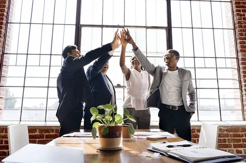 Group of diverse people stacking hands in the middle