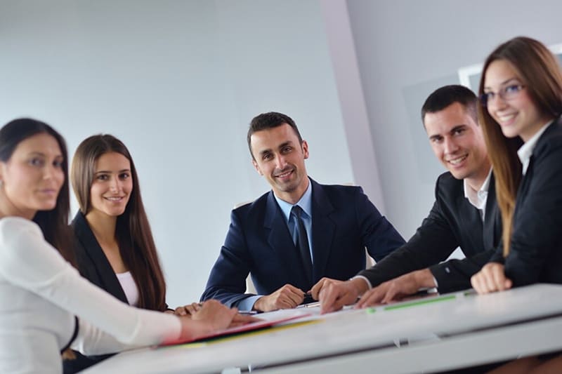 A group of people in a business meeting