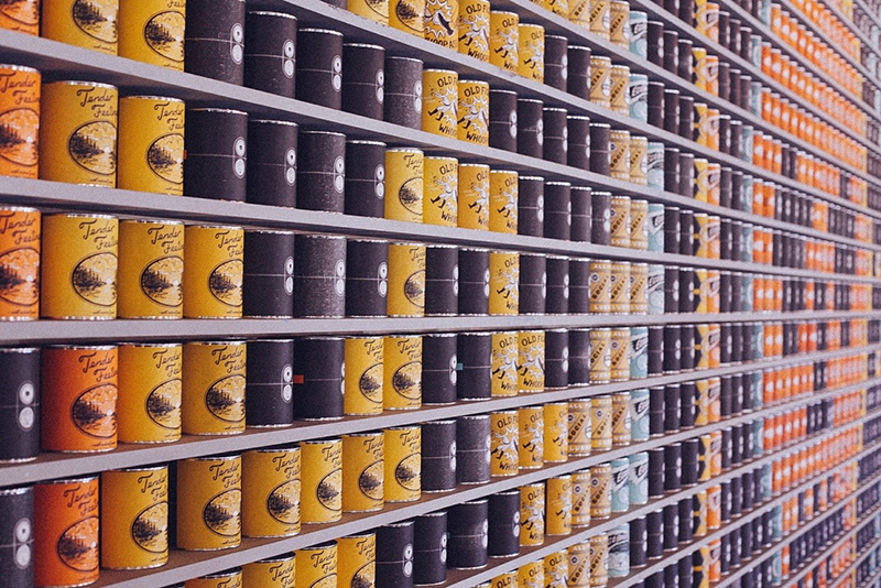 multiple rows of cans stacked on shelves
