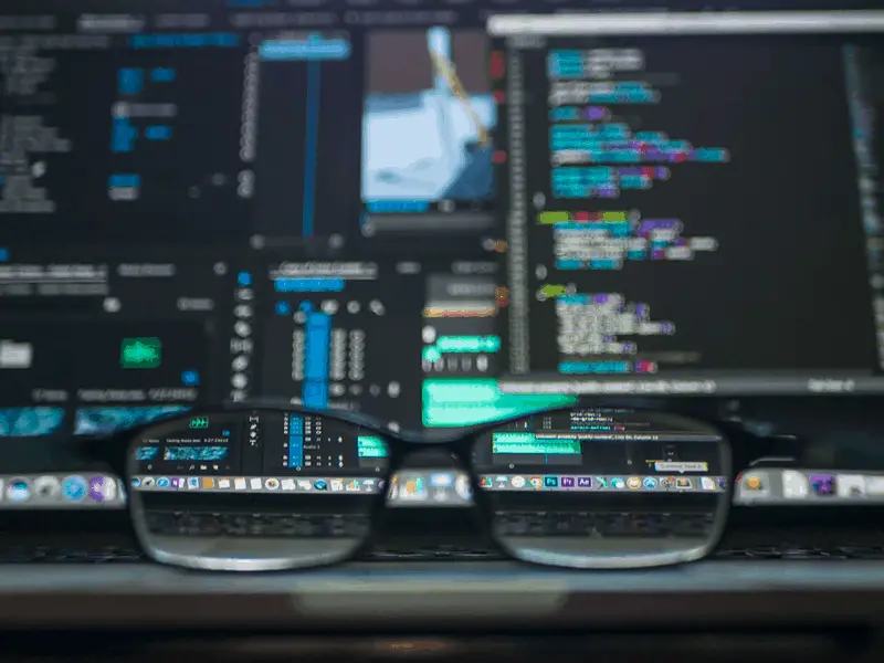 A focus view of eye glasses in front of forex trading chart in computer screen