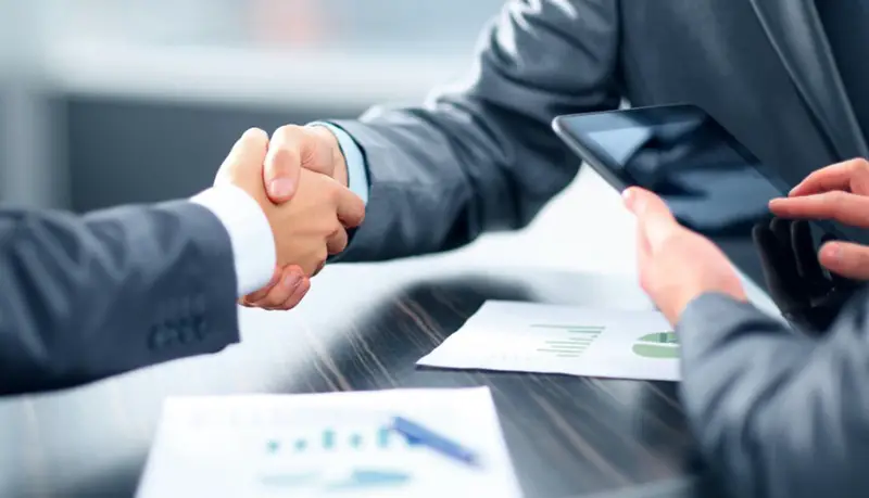 Insurance broker shaking hands with customer
