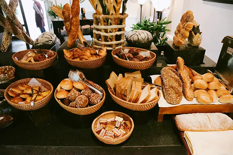 Different kind of bread on brown wooden tray